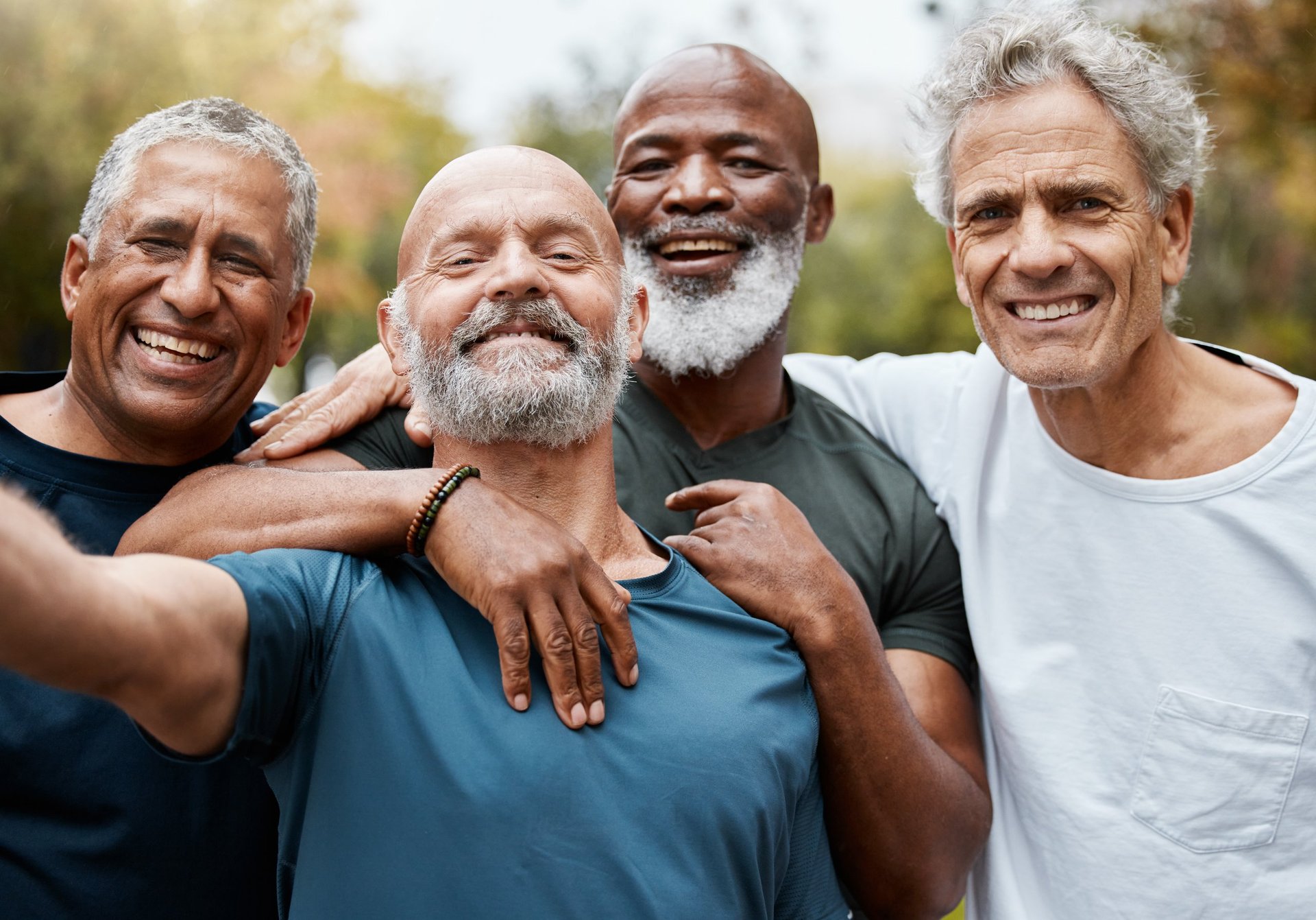 Group of diverse middle-aged men standing together representing unity and community in recovery