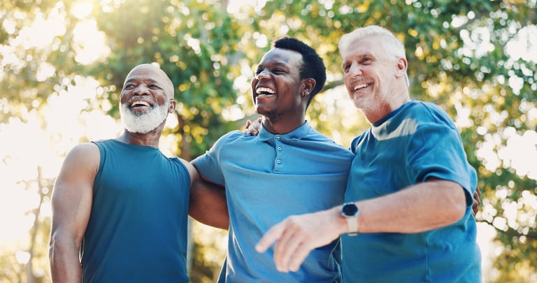 Senior diverse men laughing and having fun together outdoors representing friendship and community support in recovery